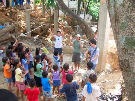 Will (center, green shirt) leading children's music in Honduras.